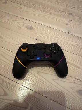 Wireless Black Game Controller with Yellow & Purple Accents